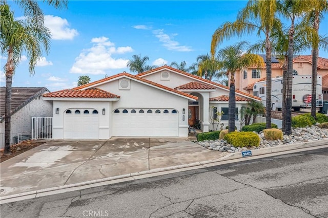 mediterranean / spanish-style home with a garage