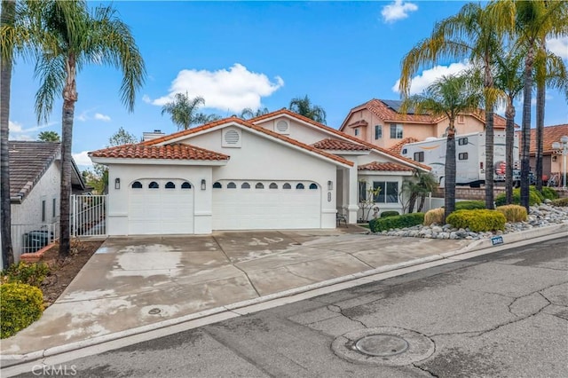 mediterranean / spanish-style home featuring a garage