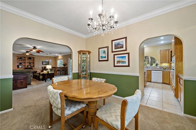 dining room featuring crown molding, ceiling fan, and light carpet