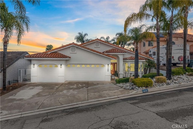 mediterranean / spanish home with a garage