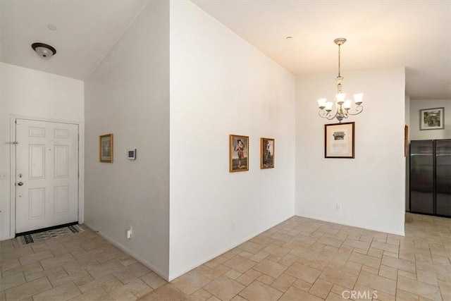 foyer entrance featuring an inviting chandelier