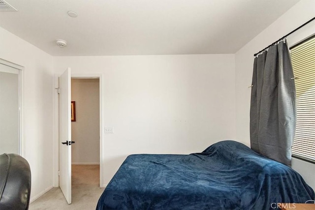 bedroom featuring light colored carpet