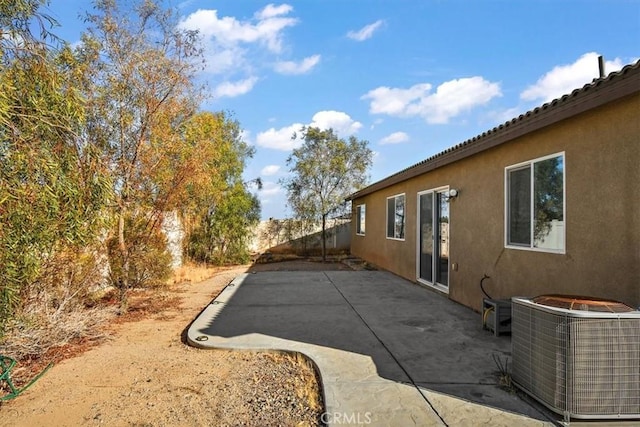 view of property exterior featuring central AC unit and a patio area