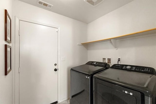 washroom featuring washing machine and clothes dryer