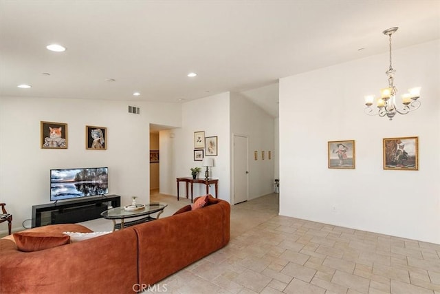 living room featuring vaulted ceiling and a notable chandelier