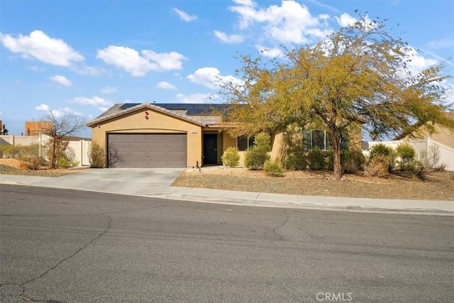 view of front of home featuring a garage and solar panels