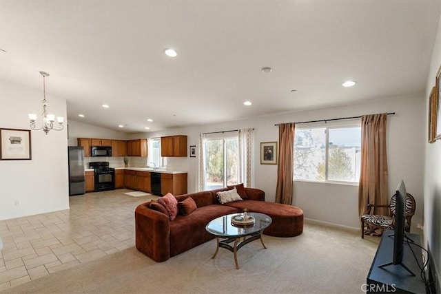 carpeted living room with vaulted ceiling and a chandelier