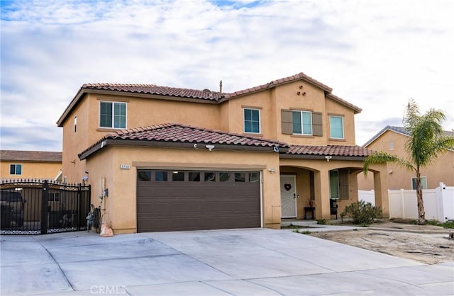 mediterranean / spanish-style house with a garage