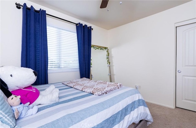 bedroom with ceiling fan and carpet flooring