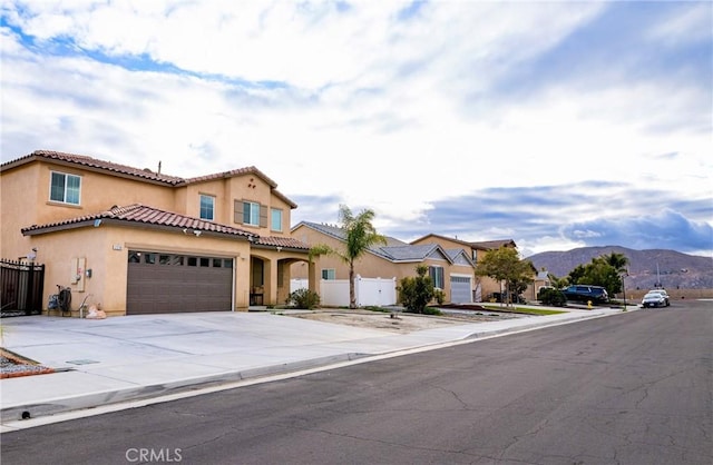 mediterranean / spanish home featuring a garage and a mountain view