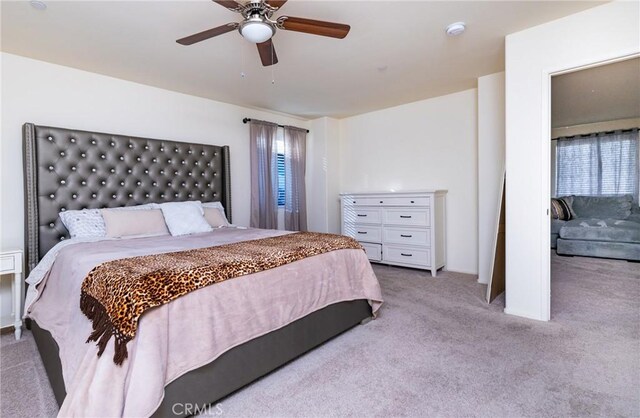 bedroom with light colored carpet and ceiling fan