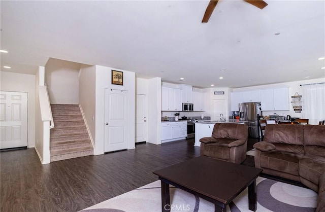 living room with dark hardwood / wood-style floors and sink