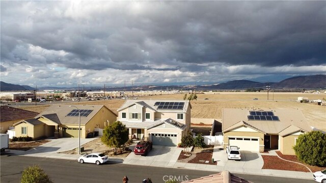 view of front of property featuring a garage and a mountain view