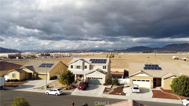 view of front of home with a garage and a mountain view