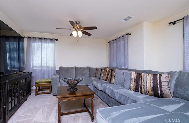 living room with light carpet and ceiling fan