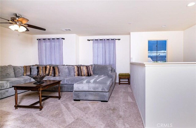 living room with light colored carpet and ceiling fan