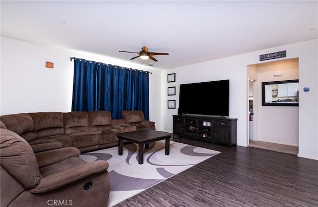 living room with ceiling fan and dark hardwood / wood-style flooring