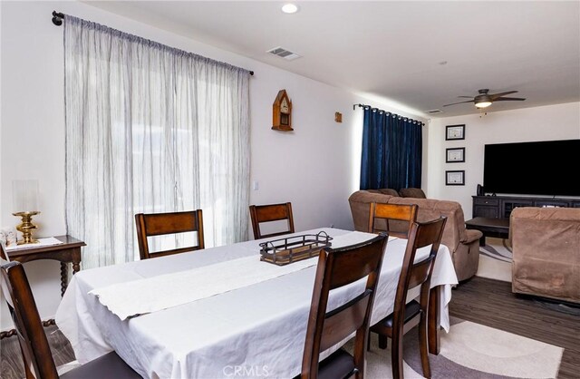 dining room featuring wood-type flooring and ceiling fan