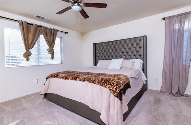 bedroom featuring ceiling fan and light carpet