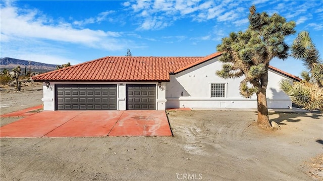 view of front of house featuring a garage and a mountain view