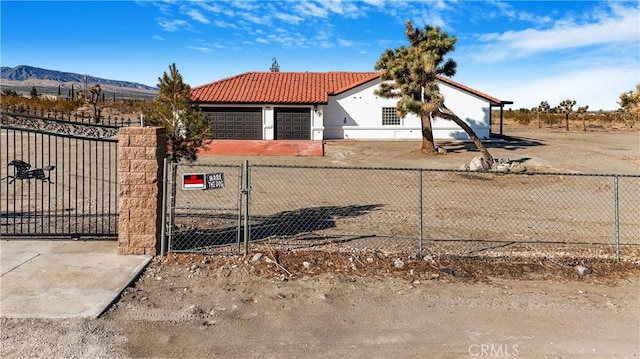 view of front facade with a garage and a mountain view