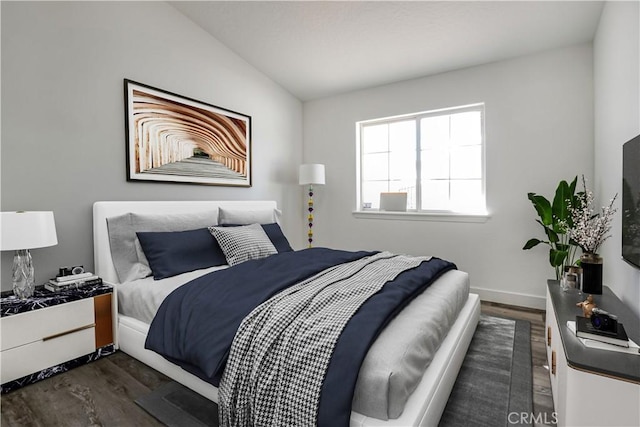 bedroom featuring lofted ceiling and dark hardwood / wood-style floors