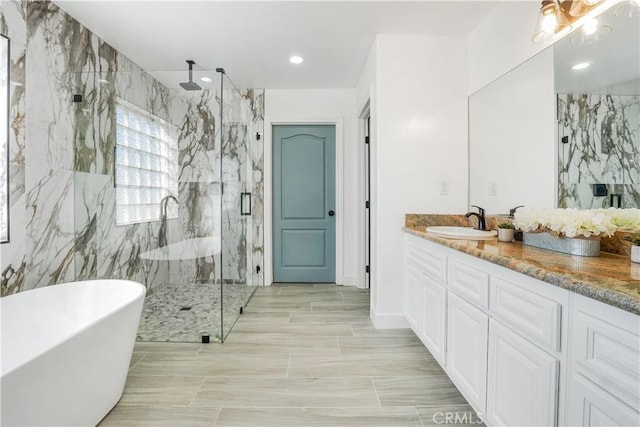 bathroom with vanity and separate shower and tub