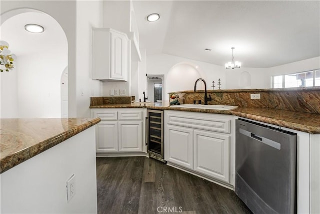 kitchen featuring sink, white cabinetry, dark stone countertops, wine cooler, and stainless steel dishwasher