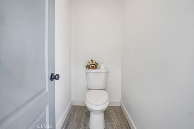 bathroom featuring hardwood / wood-style floors and toilet