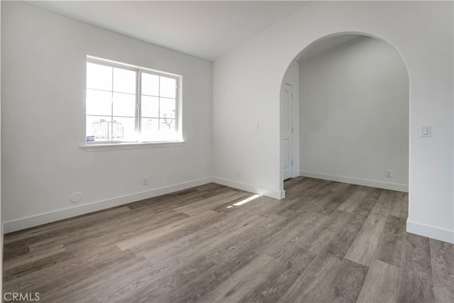 empty room with hardwood / wood-style floors