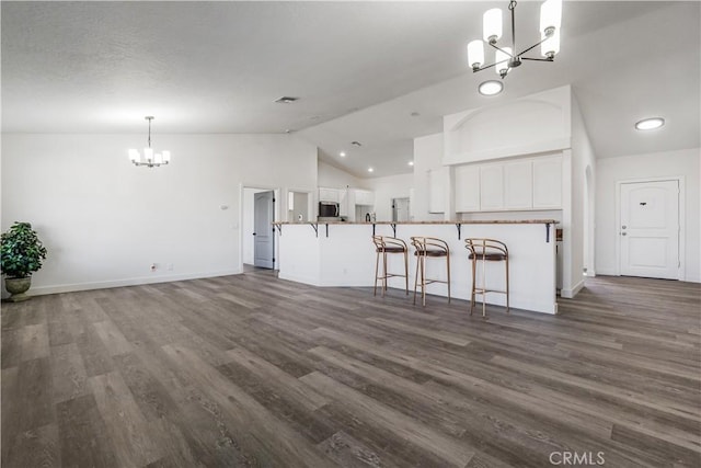 kitchen featuring a notable chandelier, dark hardwood / wood-style floors, white cabinets, and kitchen peninsula