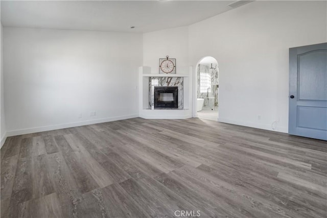 unfurnished living room featuring a fireplace and hardwood / wood-style floors