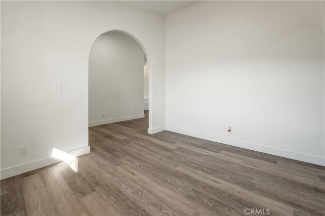 empty room with dark hardwood / wood-style floors