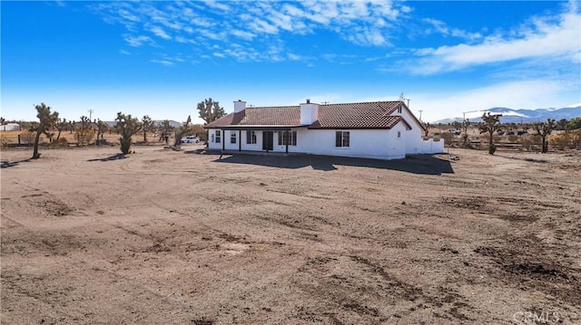 back of property featuring a mountain view