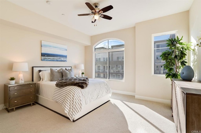 bedroom featuring light carpet and ceiling fan