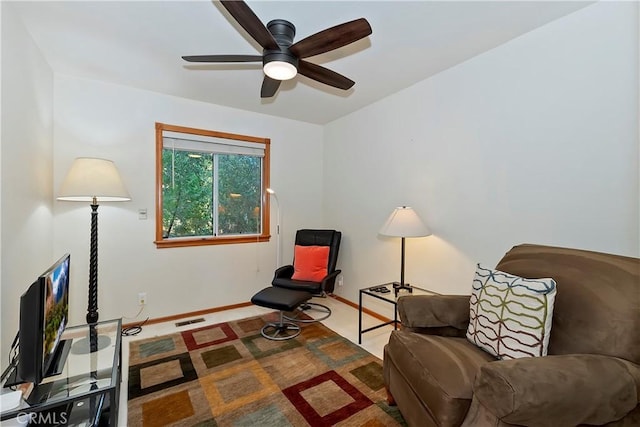 sitting room featuring carpet and ceiling fan