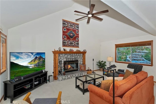 carpeted living room with ceiling fan, a stone fireplace, and high vaulted ceiling