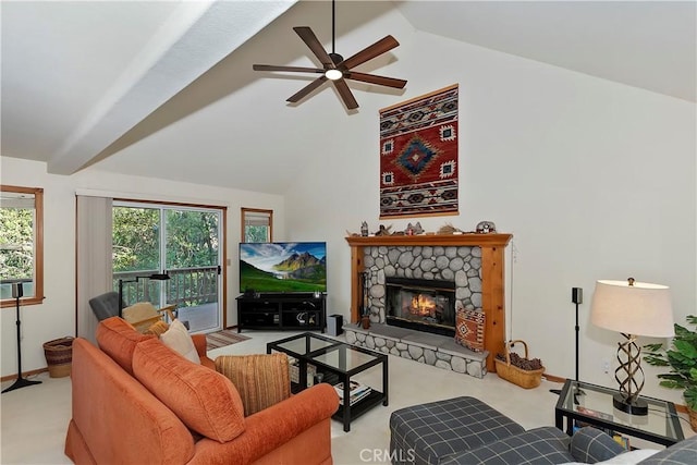 carpeted living room with ceiling fan, a fireplace, and high vaulted ceiling