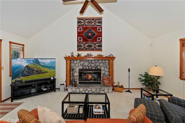 living room with vaulted ceiling, a stone fireplace, light carpet, and ceiling fan