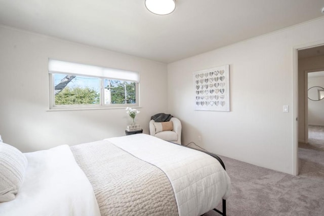 carpeted bedroom featuring ornamental molding