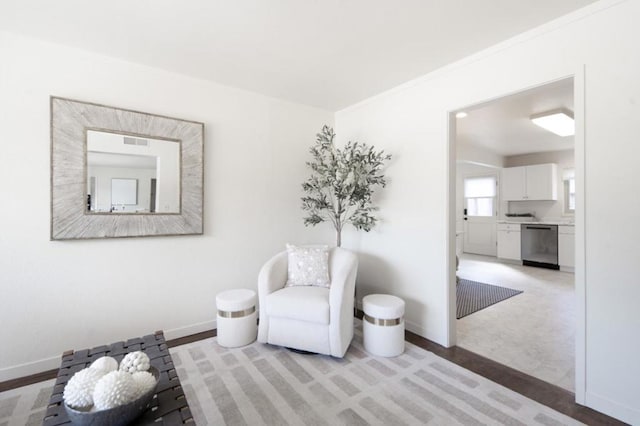 living area featuring crown molding