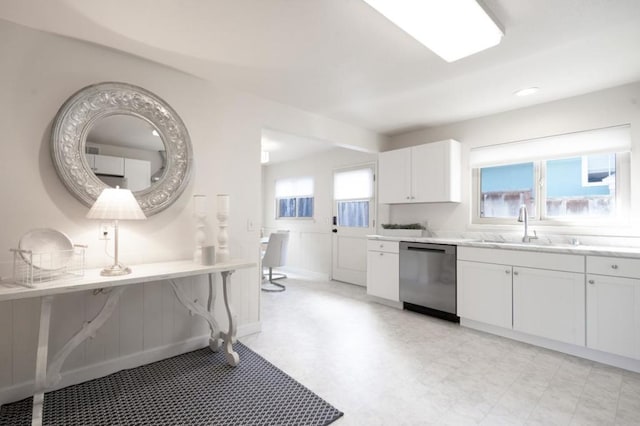 kitchen with white cabinetry, sink, and dishwasher