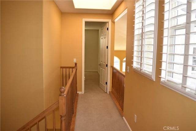 hallway featuring light colored carpet