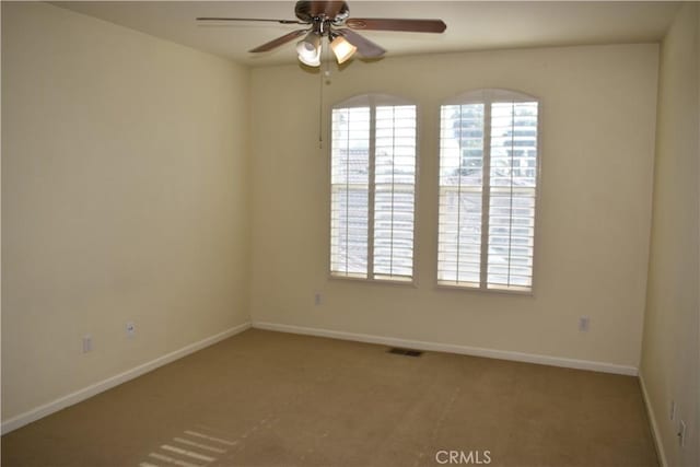 unfurnished room with ceiling fan and carpet floors