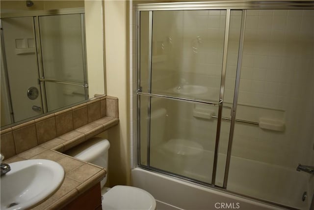 full bathroom with toilet, vanity, bath / shower combo with glass door, and decorative backsplash