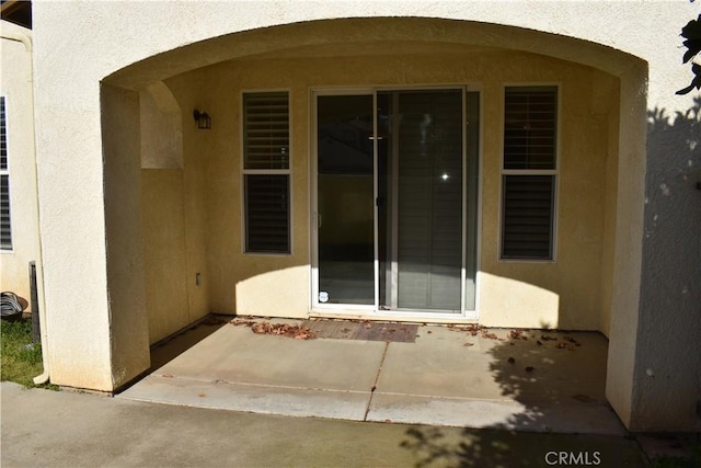 doorway to property featuring a patio area