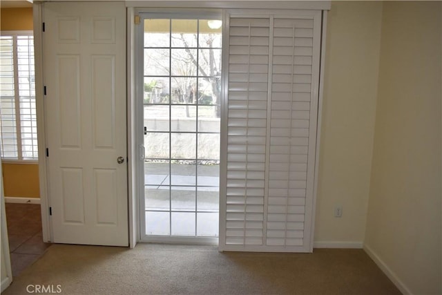 doorway featuring light colored carpet