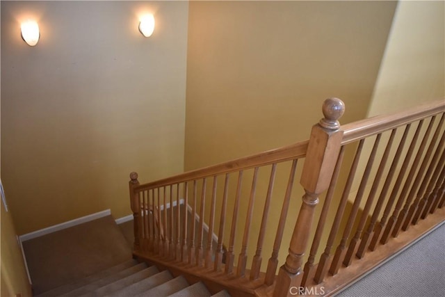 staircase featuring carpet flooring