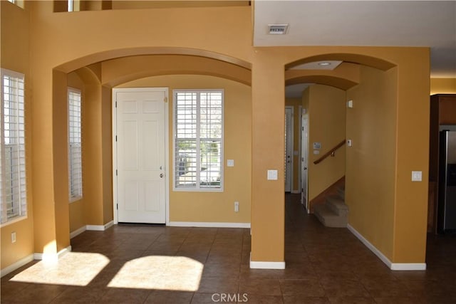 foyer entrance featuring dark tile patterned floors