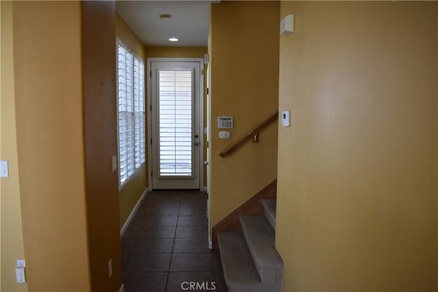 entryway featuring dark tile patterned flooring